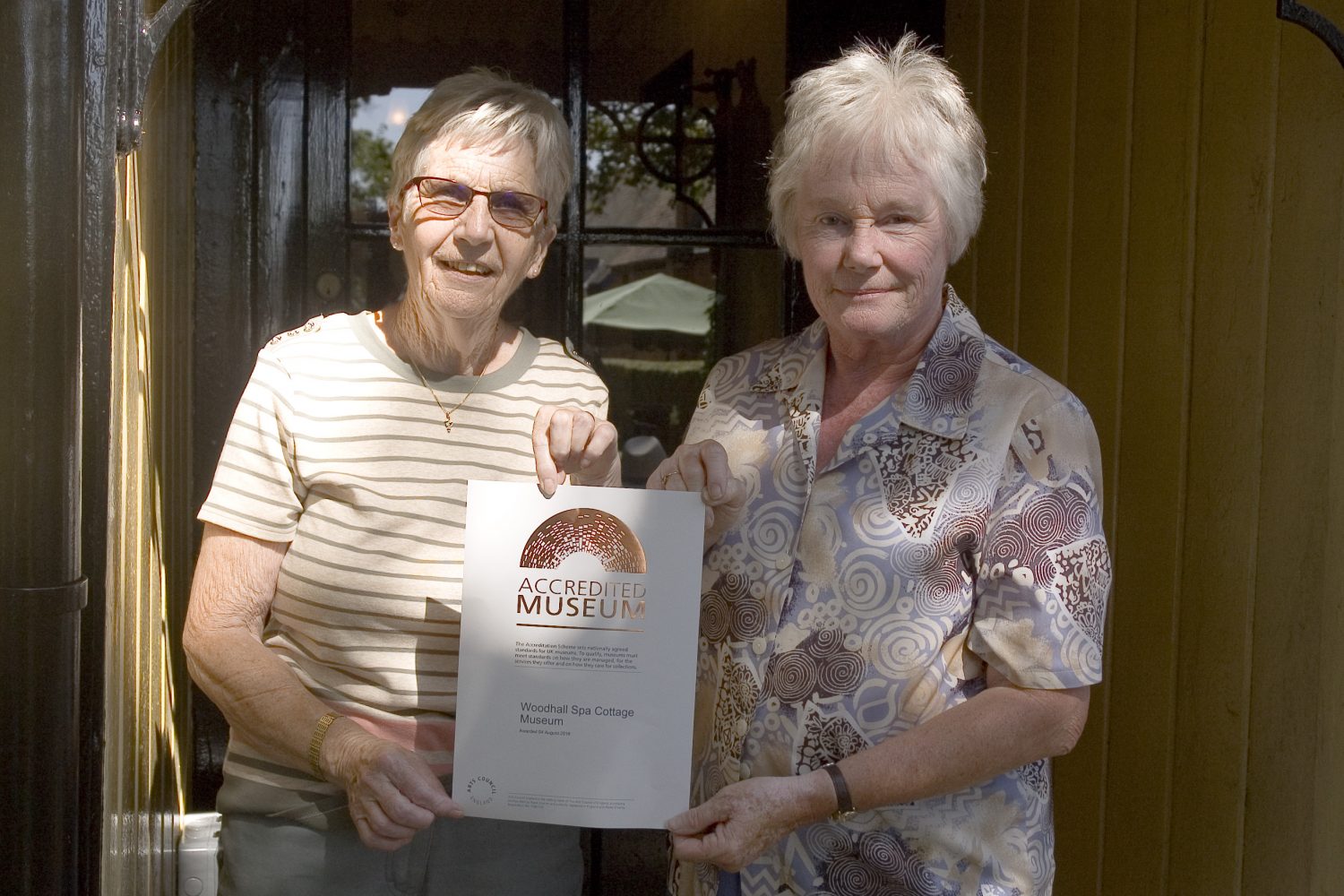 Our chaiman Gill Noble with deputy chairman Patricia Duke-Cox and the accreditation certificate