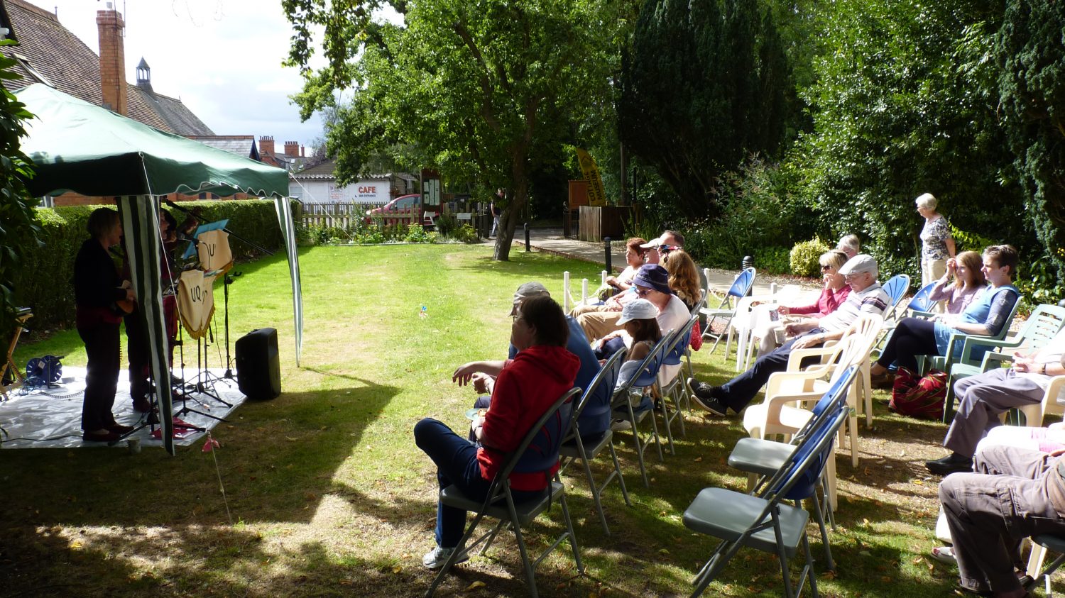 Visitors enjoying the sunshine and music.