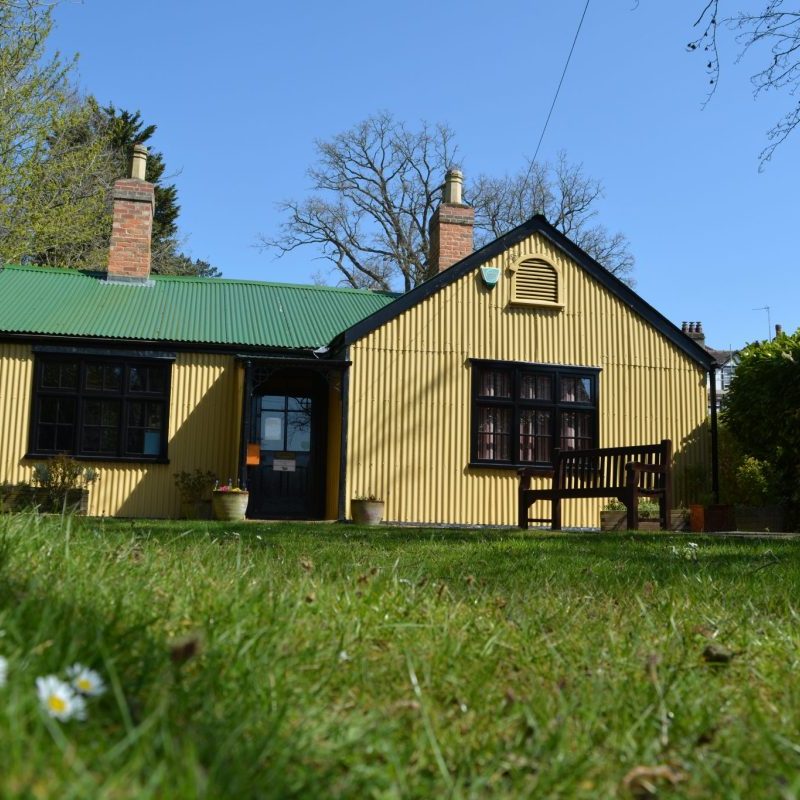 photo of the cottage museum in sunshine with daisies photo of the cottage museum in sunshine with daisies