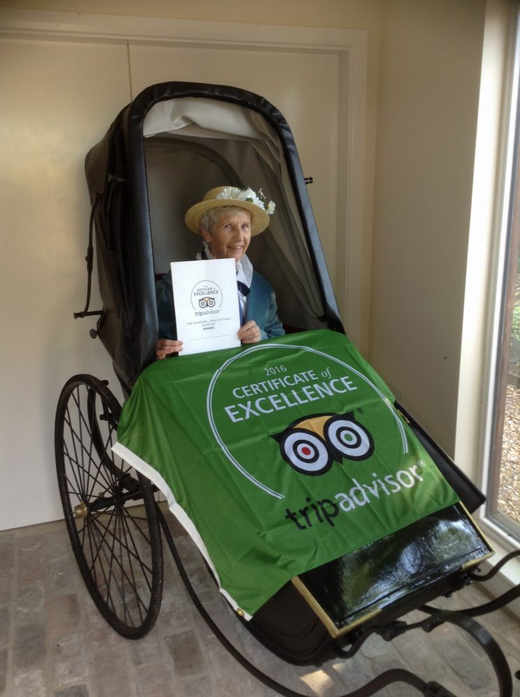 Our chairman, Gill Noble, with the TripAdvisor 2016 Certificate of Excellence relaxing in the restored Bathchair.